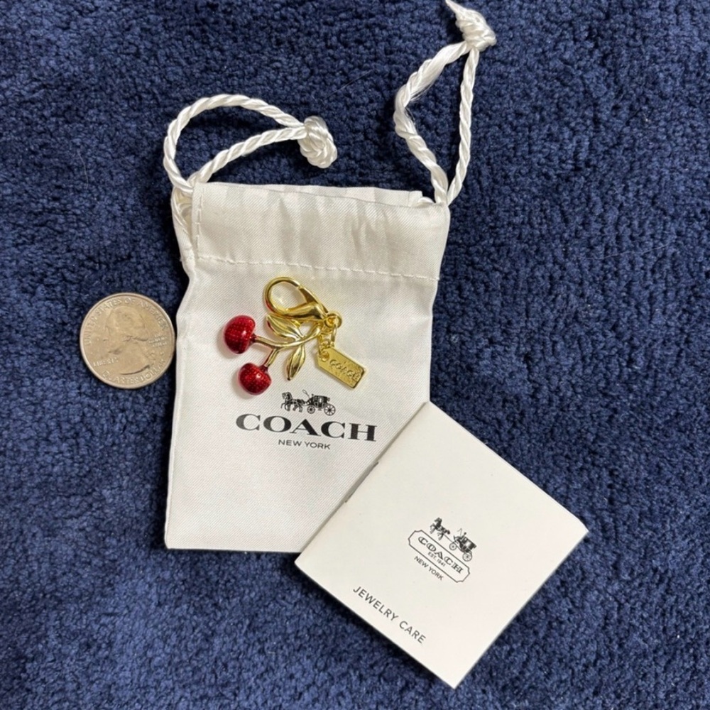 COACH Gold n Red Cherry Charm Keychain
NWT 
Comes with dust bag 
Small
CCX77